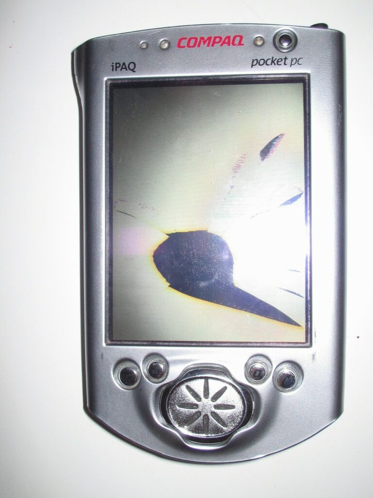 Compaq iPAQ with a large black shape showing where the screen was damaged