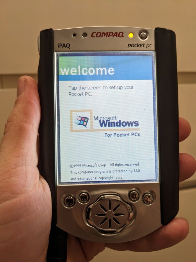 Me holding a Compaq iPaq Pocket PC