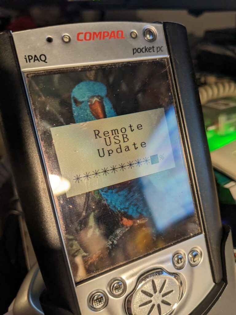 Compaq iPAQ pocket PC showing image of a parrot and remote USB update screen 