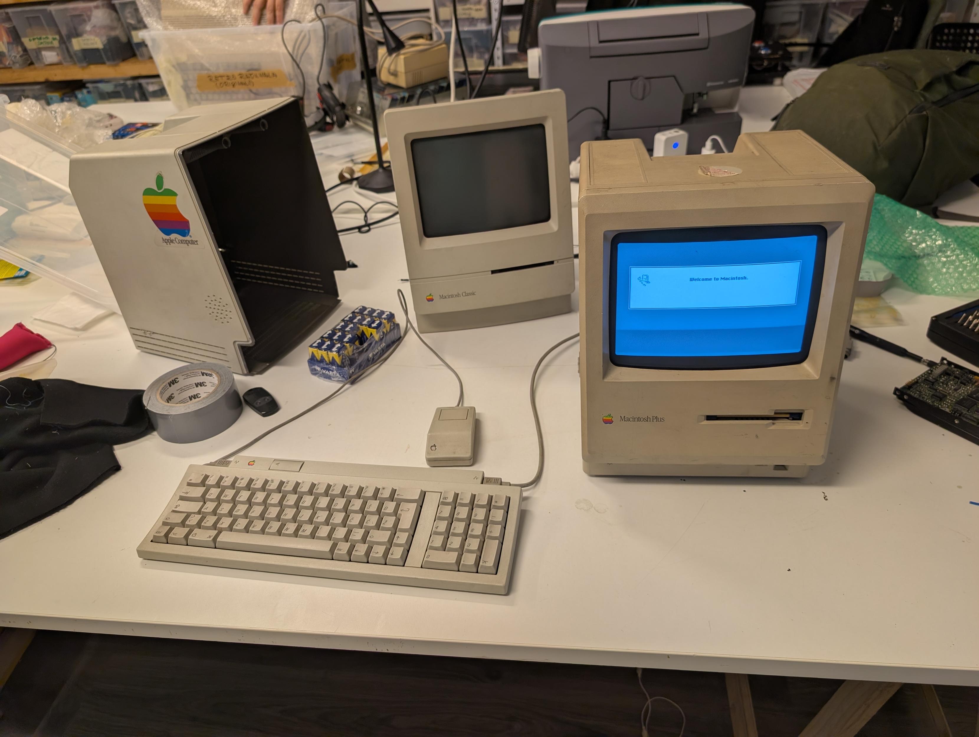 A few compact macs on a table, one is open